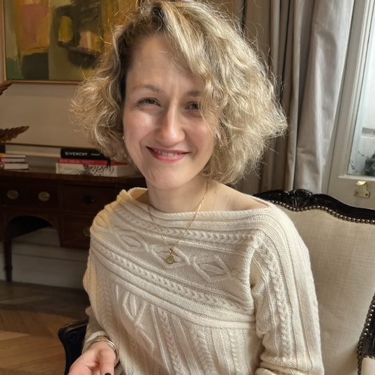 Nathalie smiling in a bright room