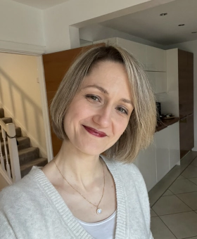 Nathalie smiling in a bright room